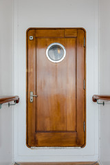Old wooden narrow door on vintage ship