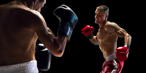 two Boxer athlete in action. isolated in black. water drops and blood in face