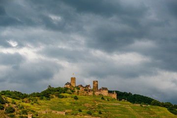 Thurant Castle and vineyards above Moselle river near Alken, Germany.