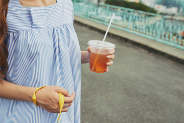 Walking with iced tea in hands