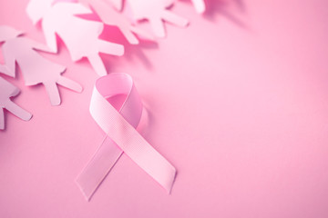 The Sweet pink ribbon shape with girl paper doll on pink background  for Breast Cancer Awareness symbol to promote  in october month campaign