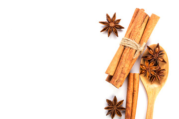 Close up brown cinnamon stick with star anise spice in wooden spoon isolated on white background...