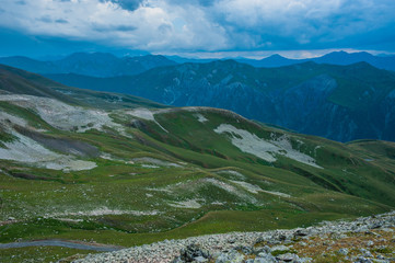 Mountain valley with snow peaks and clouds in Tetnuldi, Mestia, Georgia