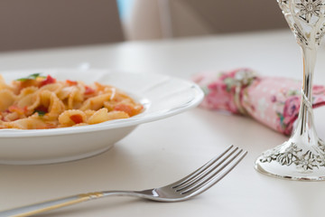 Pasta served with a goblet of wine