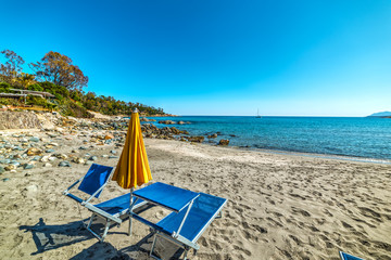 Fototapeta na wymiar Umbrella and beach chairs on the sand