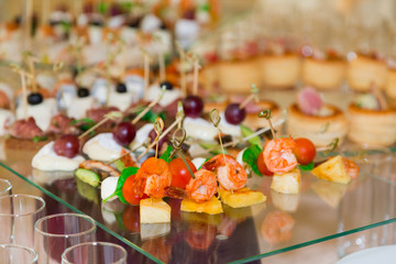 Snacks, fish and meat specialities on the buffet. A gala reception. Served tables. Catering.