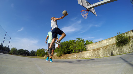 Fototapeta na wymiar Lay up shot on a basketball playground
