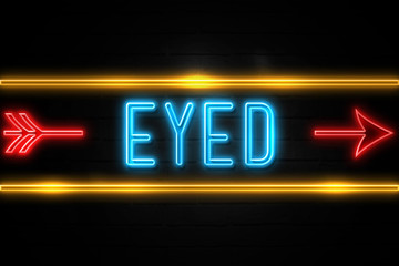Eyed  - fluorescent Neon Sign on brickwall Front view