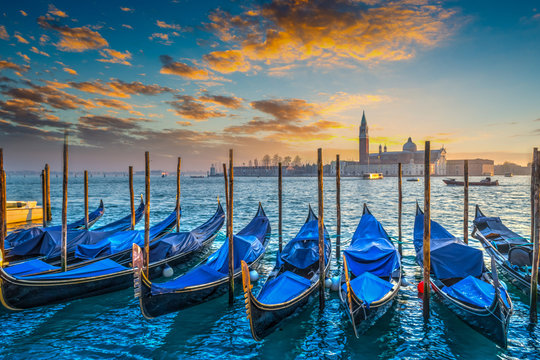 Blue gondolas in Venice at sunset