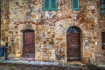 Doors in a rustic wall in Monteriggioni