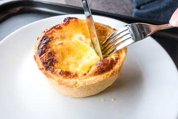 Someone Cutting a Dish of Pork Ham Quiche