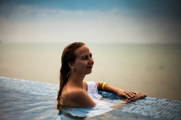 Girl in a swimming pool with Black sea view, Crimea, Russia