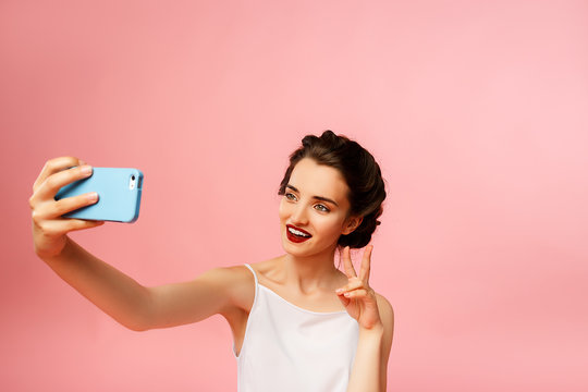 happy girl with blue smartphone in hand