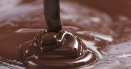 pouring melted premium dark chocolate