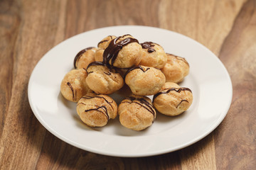 profiteroles with fine dark chocolate on plate