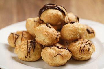profiteroles with fine dark chocolate on plate