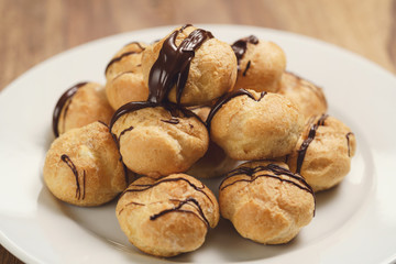 profiteroles with fine dark chocolate on plate