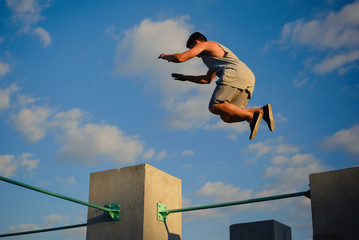 Young guy parkour jumping on the walls