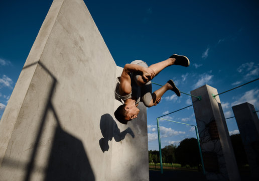 Young boy parkour a jump