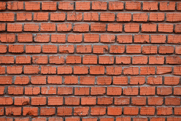 Wall of red old brick in cracks