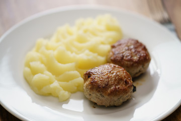 homemade cutlet with mashed potatoes on wood table