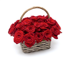 Fototapeta na wymiar Red roses in a wicker basket