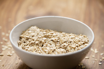 oat flakes in white bowl on wood table