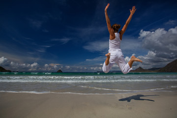 Young woman plays at the sea