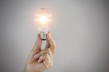 concept light bulb in hand woman showing