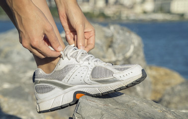 Naklejka premium Woman Tying Sports Shoe