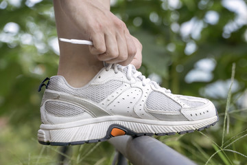 Woman Tying Sports Shoe