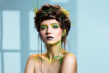 Young woman, nature themed makeup. Beautiful caucasian girl. The queen of nature.
