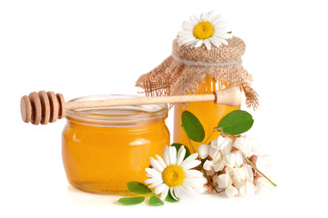 Obraz na płótnie Canvas Jar of honey with flowers of acacia and chamomile isolated on white background
