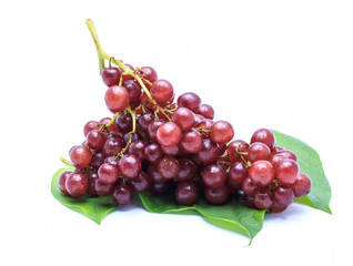 Ripe red grape. Pink bunch with leaves on white background