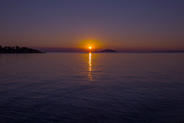 Sea view from beach with sundown  sky.Summer rest on the beach of Greece.