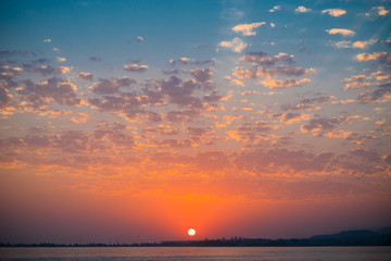 Background blur seascape and sunset with reflection and bokeh in the calm sea