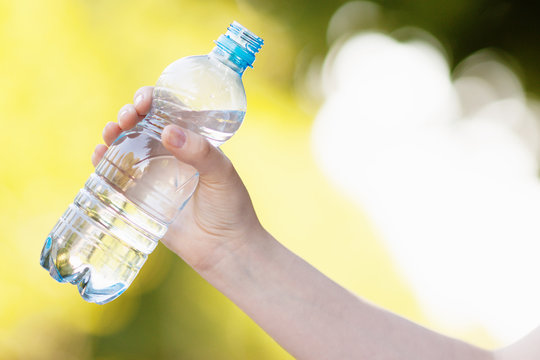 Hand holding fresh water bottle 