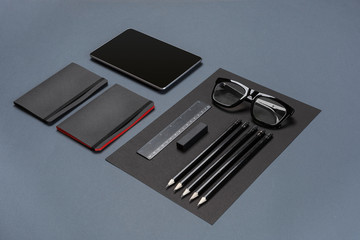 Set of black office stationery on a gray background, flat lay