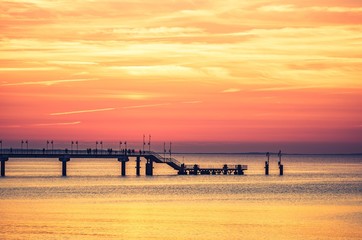 Fototapeta premium Pier in Miedzyzdroje resort - Baltic seascape at sunset, Poland