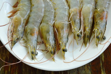 raw prawn ingredient food arranged on white plate