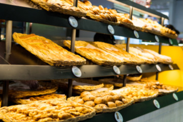 Blurry Background of the shelves of sweets bakery. The bread have just finished, fresh and delicious.