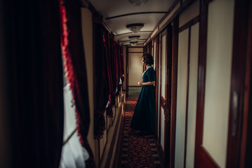 Young woman travels, vintage train compartment