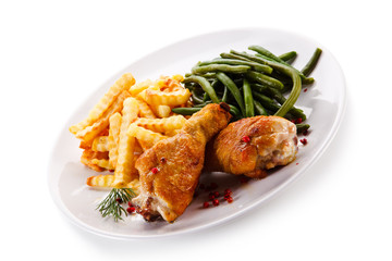 Grilled drumsticks with french fries and vegetables 