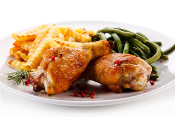 Grilled drumsticks with french fries and vegetables 