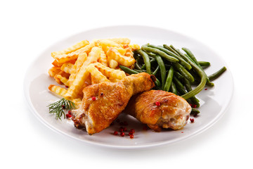 Grilled drumsticks with french fries and vegetables 