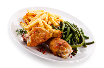 Grilled drumsticks with french fries and vegetables 