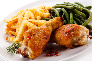 Grilled drumsticks with french fries and vegetables 