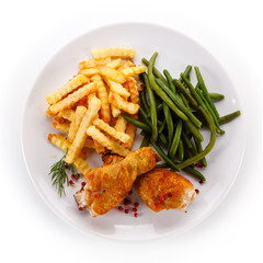 Grilled drumsticks with french fries and vegetables 