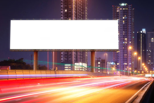 Blank billboard on light trails, street, city and urban in the night - can advertisement for display or montage product or business