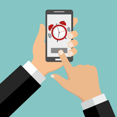 phone with an alarm clock in hand